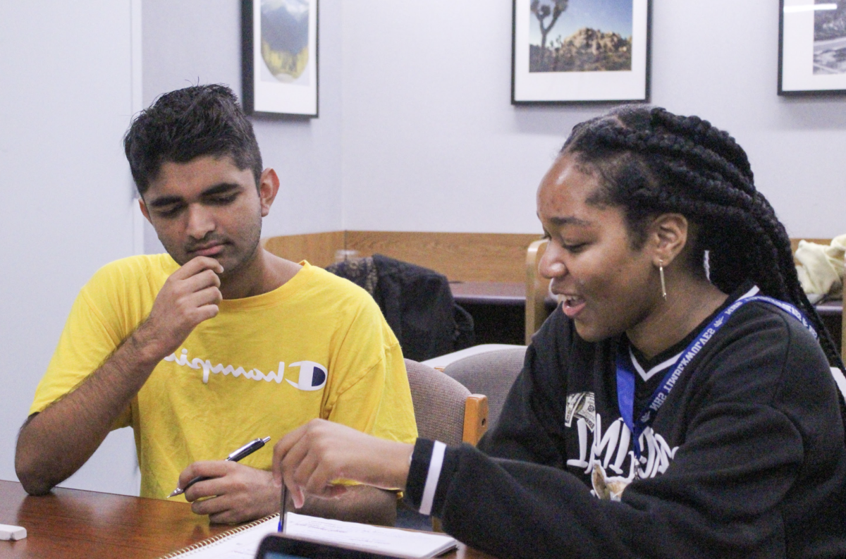 EMPOWERING MINDS: Peer tutor senior Daijelle Morris helps a student understand math concepts.